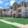 a large building with a lawn in front of it