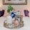 a bed with a vase and a picture frame above it