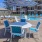 a table and chairs next to a pool