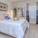 a bedroom with a bed and a fan