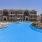 a swimming pool in front of a large building