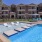 a swimming pool in front of a large building