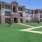 a large building with a lawn in front of it