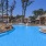 a swimming pool with a building in the background