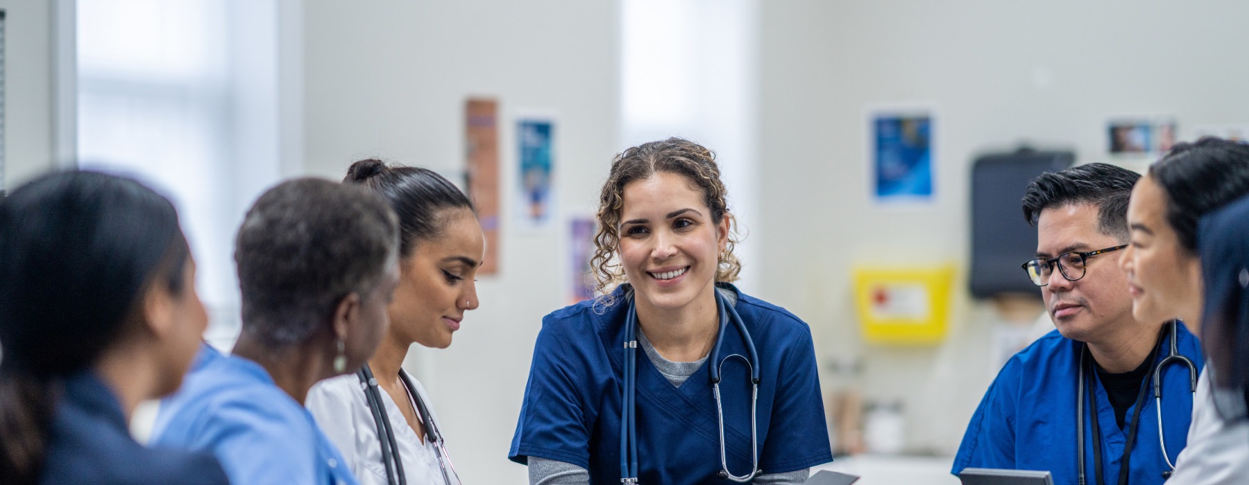 Group of medical personnel sitting around a table having a meeting