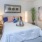 a bedroom with a bed and a plant